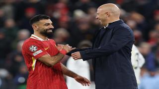 Liverpool's Arne Slot and Mohamed Salah shake hands on the pitch after another victory